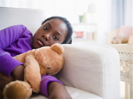 619-06197838
© Masterfile Royalty-Free
Model Release: Yes
Property Release: No
Black girl laying on sofa with teddy bear